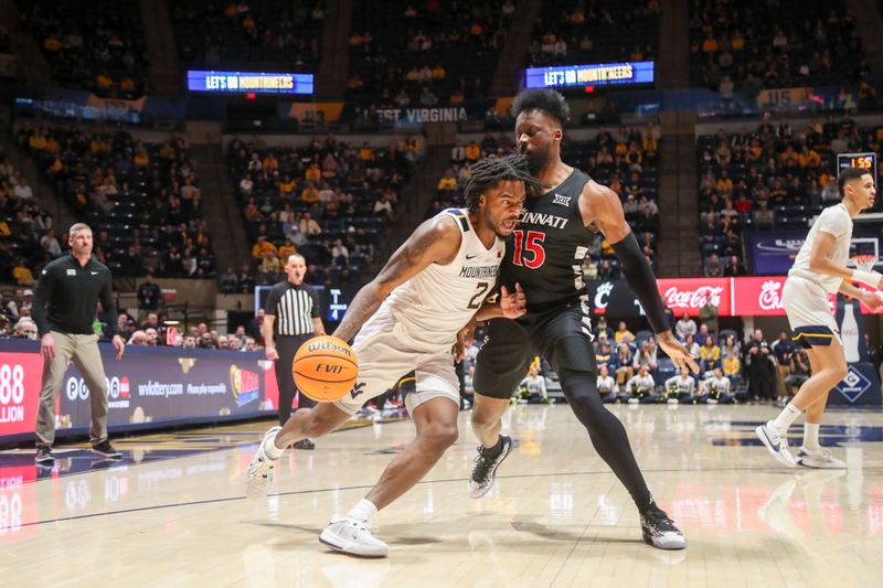 Jan 31, 2024; Morgantown, West Virginia, USA; West Virginia Mountaineers guard Kobe Johnson (2) drives against Cincinnati Bearcats forward John Newman III (15) during the second half at WVU Coliseum. Mandatory Credit: Ben Queen-USA TODAY Sports