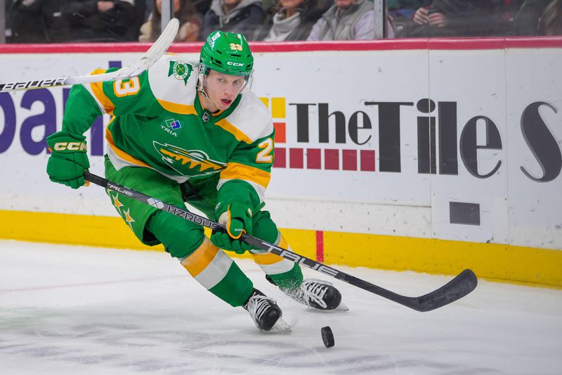 Dec 23, 2023; Saint Paul, Minnesota, USA; Minnesota Wild center Marco Rossi (23) skates with the puck against the Boston Bruins in the second period at Xcel Energy Center. Mandatory Credit: Brad Rempel-USA TODAY Sports