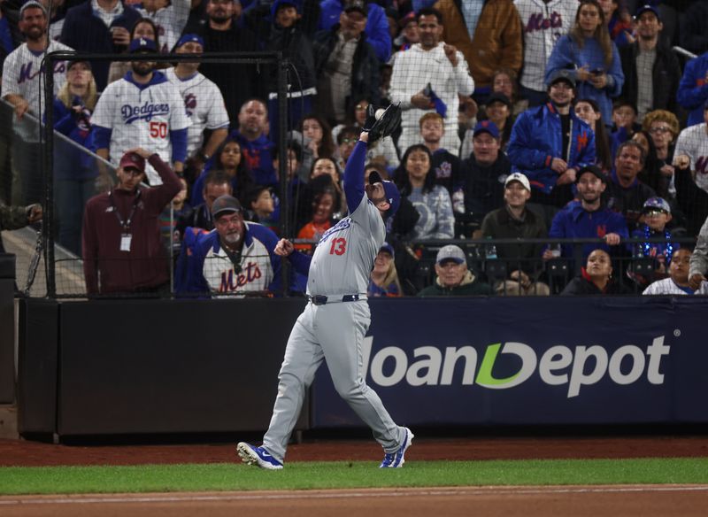 Oct 18, 2024; New York City, New York, USA; Los Angeles Dodgers third baseman Max Muncy (13) catches a pop-fly from New York Mets left fielder Brandon Nimmo (9, not pictured) during the fifth inning during game five of the NLCS for the 2024 MLB playoffs at Citi Field. Mandatory Credit: Vincent Carchietta-Imagn Images