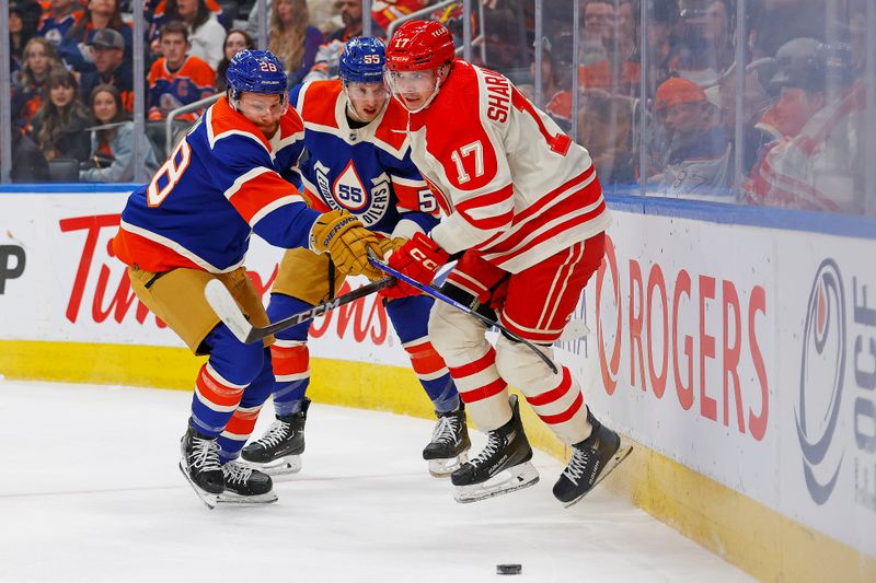 Feb 24, 2024; Edmonton, Alberta, CAN; Calgary Flames forward Yegor Sharangovich (17) and Edmonton Oilers forward Connor Brown (28) battle along the boards for a loose puck during the first period at Rogers Place. Mandatory Credit: Perry Nelson-USA TODAY Sports