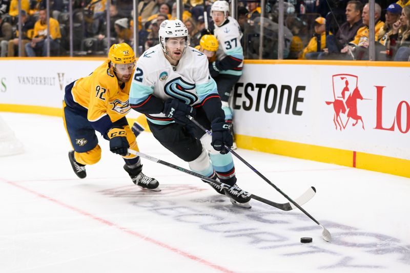 Oct 15, 2024; Nashville, Tennessee, USA;  Nashville Predators center Tommy Novak (82) pokes at the puck as Seattle Kraken left wing Tye Kartye (12) skates during the second period at Bridgestone Arena. Mandatory Credit: Steve Roberts-Imagn Images