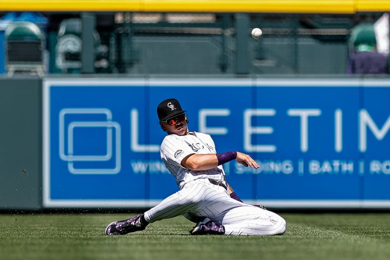 Sep 1, 2024; Denver, Colorado, USA; Colorado Rockies left fielder Jordan Beck (27) is unable to field the ball in the first inning against the Baltimore Orioles at Coors Field. Mandatory Credit: Isaiah J. Downing-USA TODAY Sports