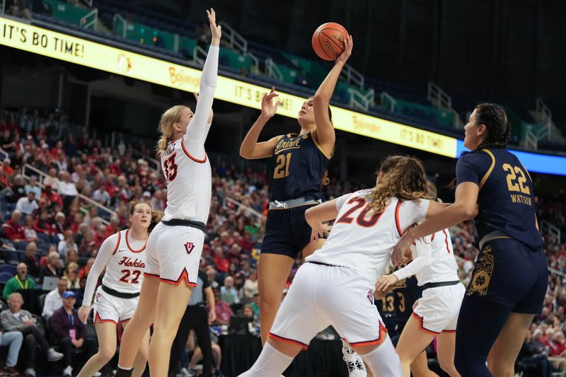 Mar 9, 2024; Greensboro, NC, USA; Notre Dame Fighting Irish forward Maddy Westbeld (21) shoots the ball over Notre Dame Fighting Irish guard Anna DeWolfe (13) during the second half at Greensboro Coliseum. Mandatory Credit: David Yeazell-USA TODAY Sports