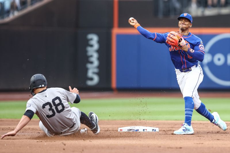 Jun 26, 2024; New York City, New York, USA;  New York Mets shortstop Francisco Lindor (12) throws past New York Yankees designated hitter J.D. Davis (38) to complete an inning ending double play in the first inning at Citi Field. Mandatory Credit: Wendell Cruz-USA TODAY Sports