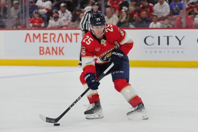 Oct 17, 2024; Sunrise, Florida, USA; Florida Panthers right wing Mackie Samoskevich (25) moves the puck against the Vancouver Canucks during the first period at Amerant Bank Arena. Mandatory Credit: Sam Navarro-Imagn Images
