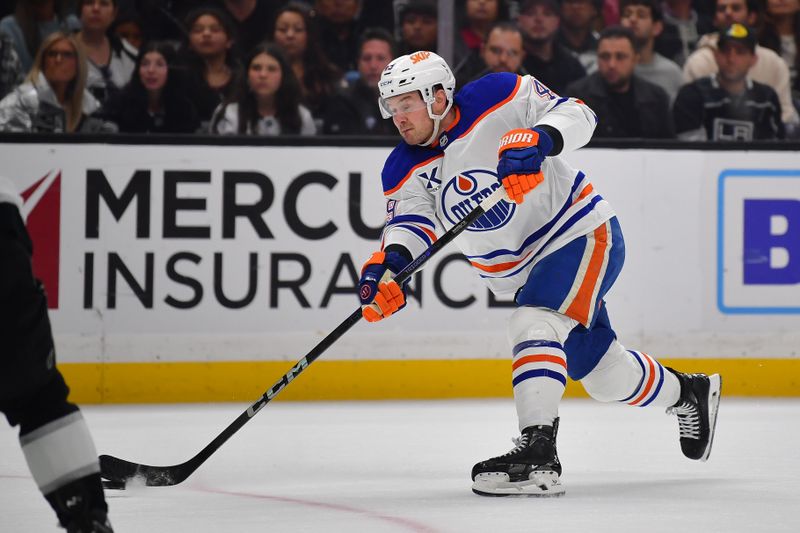 Apr 29, 2025; Los Angeles, California, USA; Edmonton Oilers defenseman Ty Emberson (49) shoots on goal against the Los Angeles Kings during the first period in game five of the first round of the 2025 Stanley Cup Playoffs at Crypto.com Arena. Mandatory Credit: Gary A. Vasquez-Imagn Images