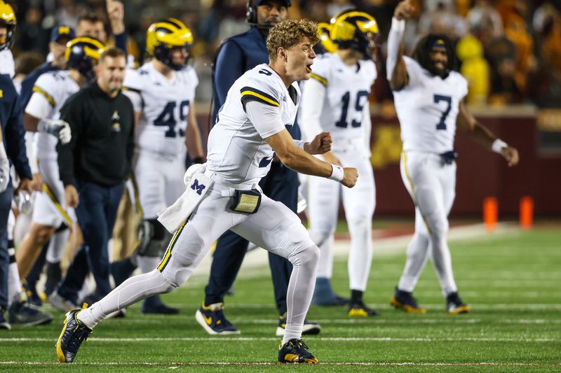 Oct 7, 2023; Minneapolis, Minnesota, USA; Michigan Wolverines quarterback J.J. McCarthy (9) celebrates after running back Leon Franklin (34) runs for a touchdown against the Minnesota Golden Gophers during the fourth quarter at Huntington Bank Stadium. Mandatory Credit: Matt Krohn-USA TODAY Sports