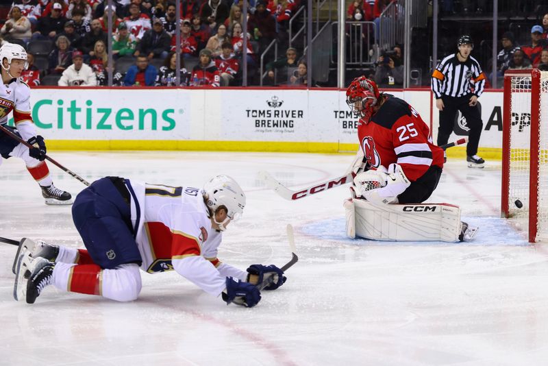 Jan 14, 2025; Newark, New Jersey, USA; Florida Panthers center Jesper Boqvist (70) scores a goal on New Jersey Devils goaltender Jacob Markstrom (25) during the third period at Prudential Center. Mandatory Credit: Ed Mulholland-Imagn Images