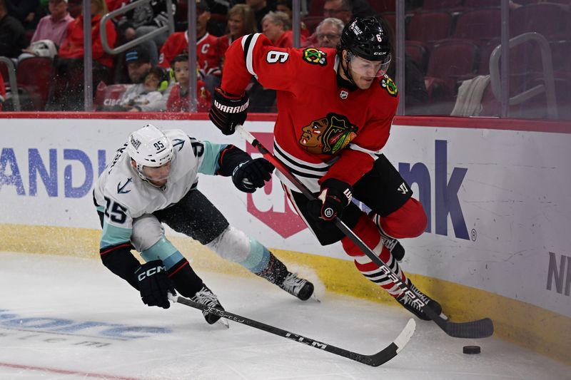Oct 23, 2022; Chicago, Illinois, USA;  Chicago Blackhawks defenseman Jake McCabe (6) controls the puck as Seattle Kraken forward Andre Buraksovsky (95) gives chase in the third period at United Center. Chicago defeated Seattle 5-4. Mandatory Credit: Jamie Sabau-USA TODAY Sports