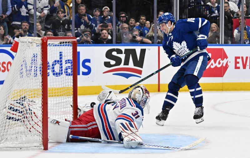 Mar 2, 2024; Toronto, Ontario, CAN;  Toronto Maple Leafs forward Mitch Marner (16) scores a goal past New York Rangers goalie Igor Shesterkin (31) in the overtime shootout at Scotiabank Arena. Mandatory Credit: Dan Hamilton-USA TODAY Sports