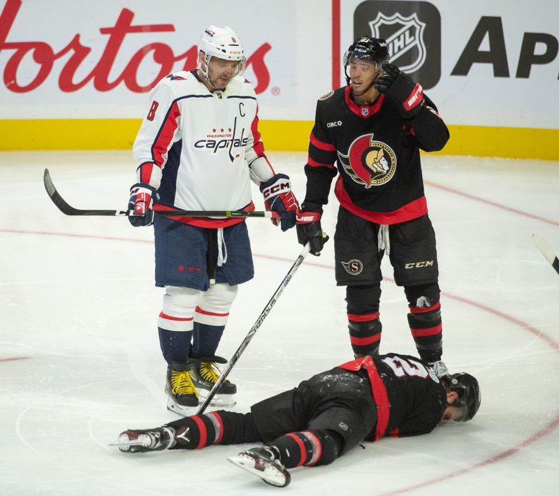 Oct 18, 2023; Ottawa, Ontario, CAN; Ottawa Senators defenseman Artem Zub (2) takes a hit to the head stopping a shot by Washington Capitals left wing Alex Ovechkin (8) in the third period at the Canadian Tire Centre. Mandatory Credit: Marc DesRosiers-USA TODAY Sports