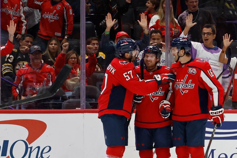 Oct 5, 2024; Washington, District of Columbia, USA; Washington Capitals defenseman Trevor van Riemsdyk (57) celebrates with teammates after scoring a goal against the Boston Bruins in the third period at Capital One Arena. Mandatory Credit: Geoff Burke-Imagn Images