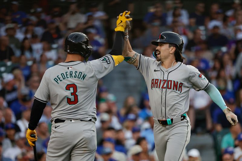 Jul 20, 2024; Chicago, Illinois, USA; Arizona Diamondbacks outfielder Corbin Carroll (7) celebrates with designated hitter Joc Pederson (3) after hitting a two-run home run against the Chicago Cubs during the fifth inning at Wrigley Field. Mandatory Credit: Kamil Krzaczynski-USA TODAY Sports