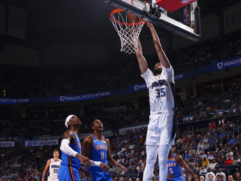 OKLAHOMA CITY, OK - NOVEMBER 4:  Goga Bitadze #35 of the Orlando Magic dunks the ball during the game on November 4, 2024 at Paycom Center in Oklahoma City, Oklahoma. NOTE TO USER: User expressly acknowledges and agrees that, by downloading and or using this photograph, User is consenting to the terms and conditions of the Getty Images License Agreement. Mandatory Copyright Notice: Copyright 2024 NBAE (Photo by Zach Beeker/NBAE via Getty Images)