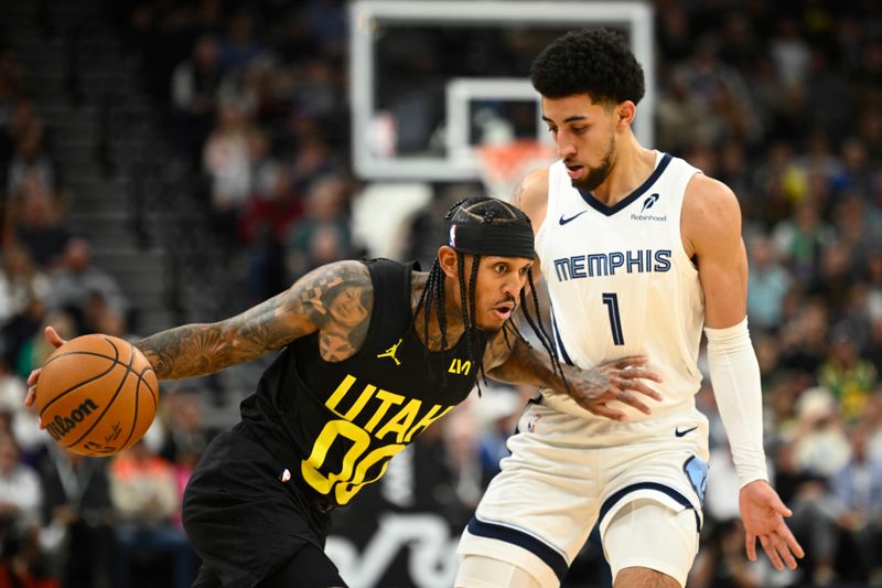 SALT LAKE CITY, UTAH - OCTOBER 23: Jordan Clarkson #00 of the Utah Jazz drives against Scotty Pippen Jr. #1 of the Memphis Grizzlies during the first quarter at Delta Center on October 23, 2024 in Salt Lake City, Utah. NOTE TO USER: User expressly acknowledges and agrees that, by downloading and or using this photograph, User is consenting to the terms and conditions of the Getty Images License Agreement. (Photo by Alex Goodlett/Getty Images)