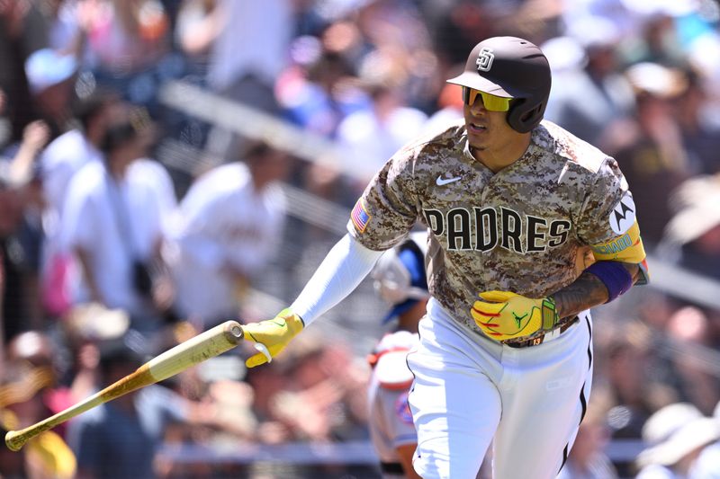 Jul 9, 2023; San Diego, California, USA; San Diego Padres third baseman Manny Machado (13) tosses his bat after hitting a three-run home run against the New York Mets during the first inning at Petco Park. Mandatory Credit: Orlando Ramirez-USA TODAY Sports