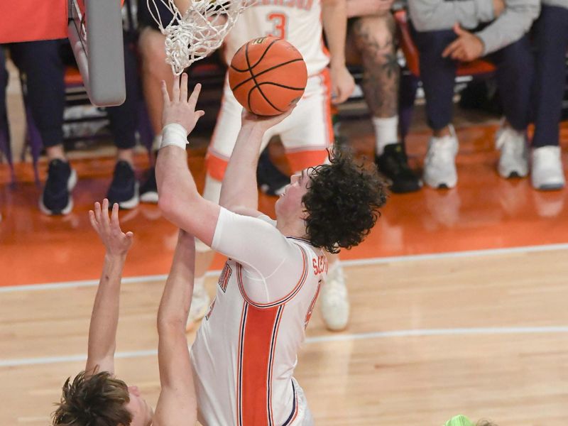 Feb 26, 2025; Clemson, South Carolina, USA; Clemson senior forward Ian Schieffelin (4) shoots the ball near Notre Dame guard Cole Certa (5) during the first half at Littlejohn Coliseum. Mandatory Credit: Ken Ruinard-Imagn Images