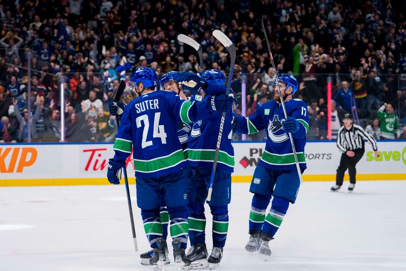 Jan 24, 2024; Vancouver, British Columbia, CAN; Vancouver Canucks forward Pius Suter (24) and forward Elias Pettersson (40) and defenseman Quinn Hughes (43) and defenseman Filip Hronek (17) celebrate Suter   s third goal of the game against the St. Louis Blues in the third period at Rogers Arena. Blues 4-3 in overtime. Mandatory Credit: Bob Frid-USA TODAY Sports