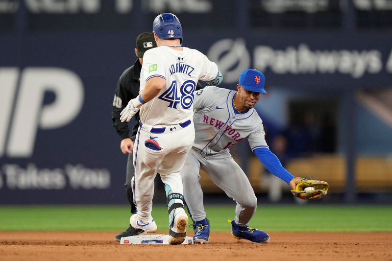 Sep 10, 2024; Toronto, Ontario, CAN; Toronto Blue Jays designated hitter Spencer Horwitz (48) beats the tag by New York Mets shortstop Francisco Lindor (12) to get a double during the seventh inning at Rogers Centre. Mandatory Credit: John E. Sokolowski-Imagn Images