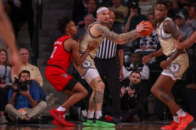 Mar 1, 2025; Atlanta, Georgia, USA; Georgia Tech Yellow Jackets forward Duncan Powell (31) is defended by North Carolina State Wolfpack guard Paul McNeil (2) in the second half at McCamish Pavilion. Mandatory Credit: Brett Davis-Imagn Images