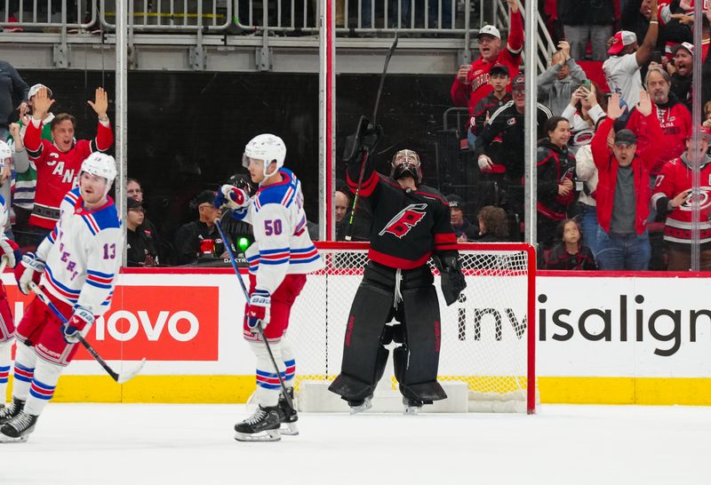 Nov 27, 2024; Raleigh, North Carolina, USA;  Carolina Hurricanes goaltender Spencer Martin (41) celebrates their victory after the game against the New York Rangers at Lenovo Center. Mandatory Credit: James Guillory-Imagn Images