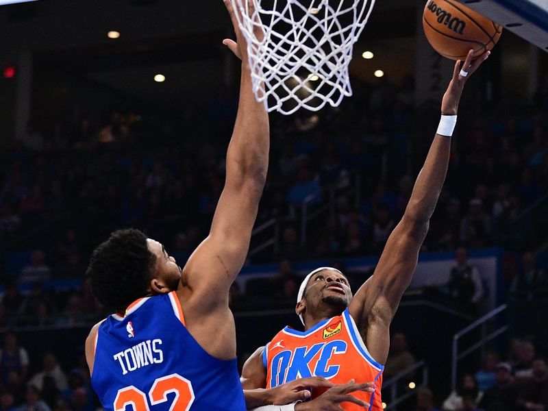 OKLAHOMA CITY, OKLAHOMA - JANUARY 03: Shai Gilgeous-Alexander #2 of the Oklahoma City Thunder goes to the rim in front of Karl-Anthony Towns #32 of the New York Knicks during the first half at Paycom Center on January 3, 2025 in Oklahoma City, Oklahoma. NOTE TO USER: User expressly acknowledges and agrees that, by downloading and or using this photograph, User is consenting to the terms and conditions of the Getty Images License Agreement. (Photo by Joshua Gateley/Getty Images)