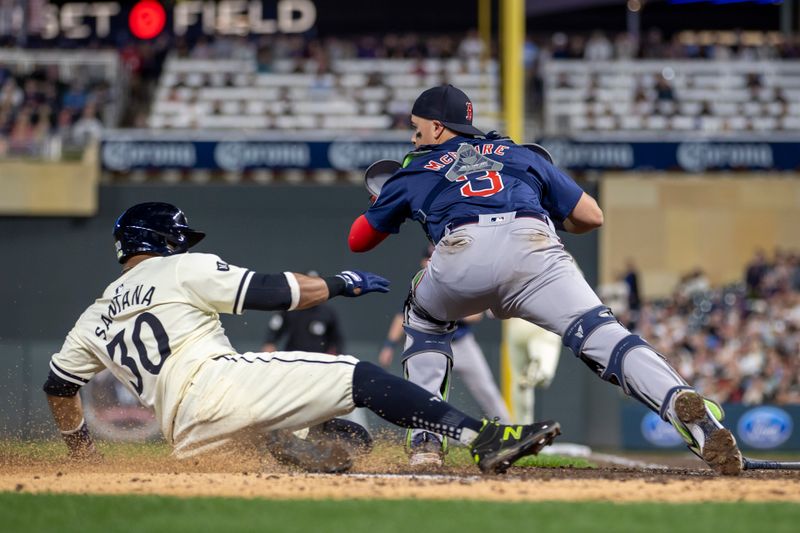 May 3, 2024; Minneapolis, Minnesota, USA; Boston Red Sox catcher Reese McGuire (3) forces out Minnesota Twins first baseman Carlos Santana (30) at home plate in the seventh inning at Target Field. Mandatory Credit: Jesse Johnson-USA TODAY Sports