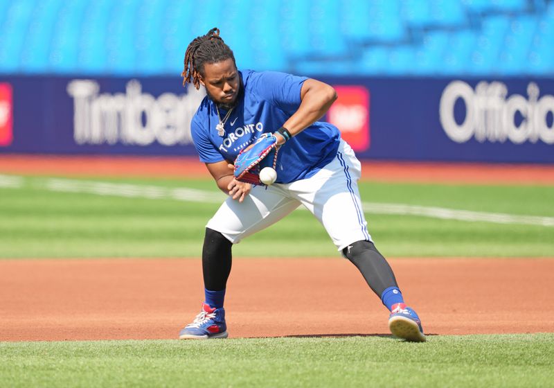 May 31, 2023; Toronto, Ontario, CAN; Toronto Blue Jays first baseman Vladimir Guerrero Jr. (27) fields balls during batting practice against the Milwaukee Brewers at Rogers Centre. Mandatory Credit: Nick Turchiaro-USA TODAY Sports