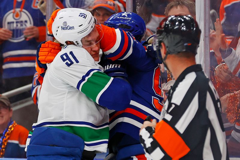 May 18, 2024; Edmonton, Alberta, CAN; Edmonton Oilers forward Evander Kane (91) and Vancouver Canucks defensemen Nikita Zadorov (91) fight during the third period in game six of the second round of the 2024 Stanley Cup Playoffs at Rogers Place. Mandatory Credit: Perry Nelson-USA TODAY Sports