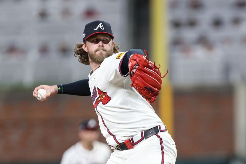 May 6, 2025; Cumberland, Georgia, USA; Atlanta Braves pitcher Pierce Johnson (38) pitches the ball against the Cincinnati Reds during the seventh inning at Truist Park. Mandatory Credit: Jordan Godfree-Imagn Images