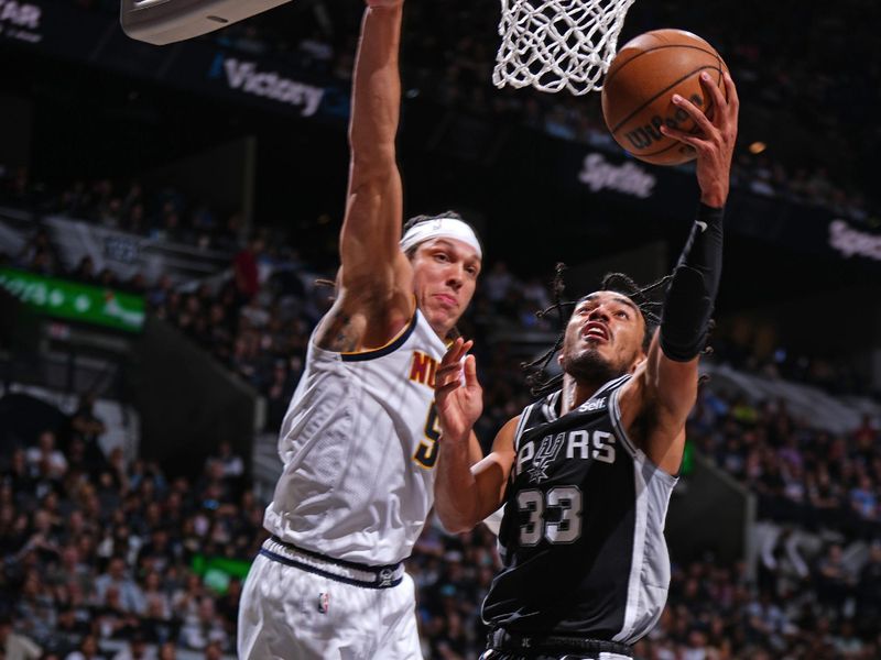 SAN ANTONIO, TX - APRIL 12: Tre Jones #33 of the San Antonio Spurs drives to the basket during the game against the Denver Nuggets on April 12, 2024 at the Frost Bank Center in San Antonio, Texas. NOTE TO USER: User expressly acknowledges and agrees that, by downloading and or using this photograph, user is consenting to the terms and conditions of the Getty Images License Agreement. Mandatory Copyright Notice: Copyright 2024 NBAE (Photos by Garrett Ellwood/NBAE via Getty Images)