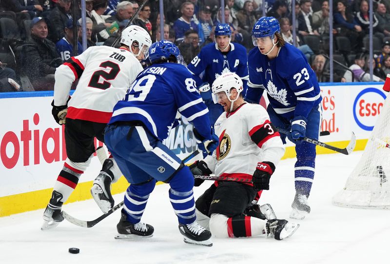 Nov 12, 2024; Toronto, Ontario, CAN; Ottawa Senators defenseman Nick Jensen (3) battles for the puck behind the net with Toronto Maple Leafs left wing Nicholas Robertson (89) during the third period at Scotiabank Arena. Mandatory Credit: Nick Turchiaro-Imagn Images