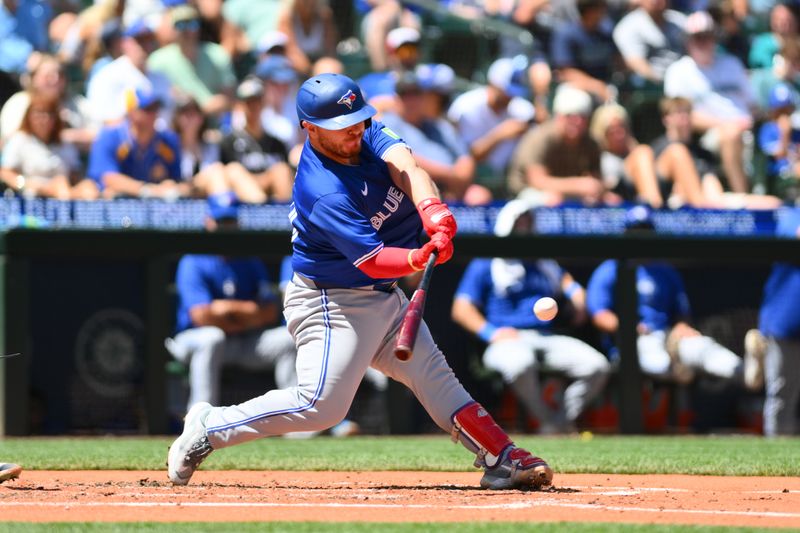 Jul 6, 2024; Seattle, Washington, USA; Toronto Blue Jays catcher Alejandro Kirk (30) hits an RBI double against the Seattle Mariners during the fourth inning at T-Mobile Park. Mandatory Credit: Steven Bisig-USA TODAY Sports