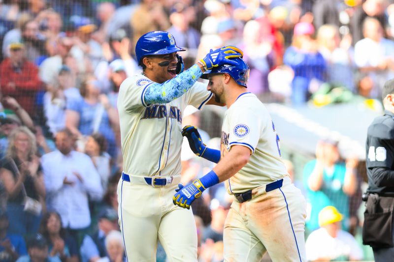 Sep 29, 2024; Seattle, Washington, USA; Seattle Mariners center fielder Julio Rodriguez (44) and catcher Cal Raleigh (29) celebrate after Raleigh hit a 2-run home run during the fifth inning at T-Mobile Park. Mandatory Credit: Steven Bisig-Imagn Images