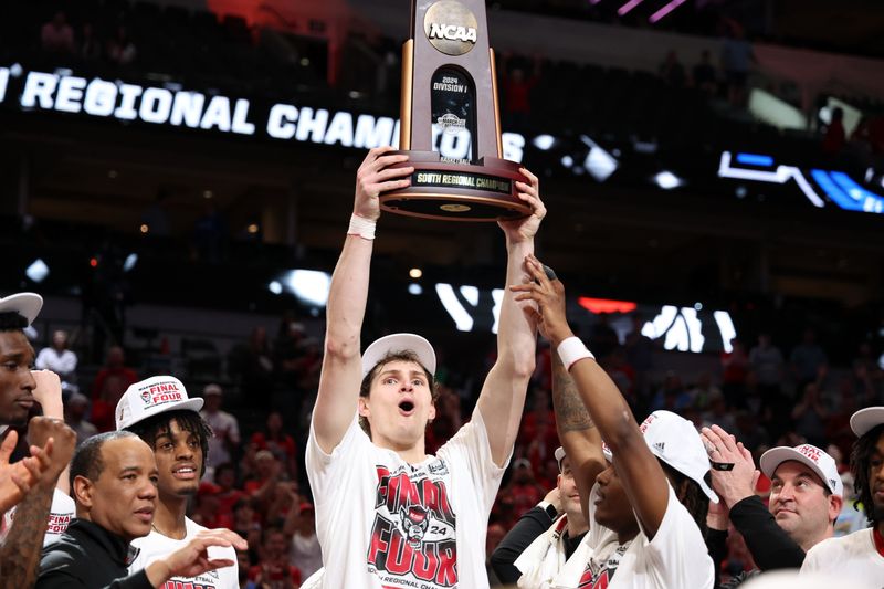 Mar 31, 2024; Dallas, TX, USA; North Carolina State Wolfpack forward Ben Middlebrooks (34) celebrates with the trophy after defeating the Duke Blue Devils in the finals of the South Regional of the 2024 NCAA Tournament at American Airline Center. Mandatory Credit: Kevin Jairaj-USA TODAY Sports