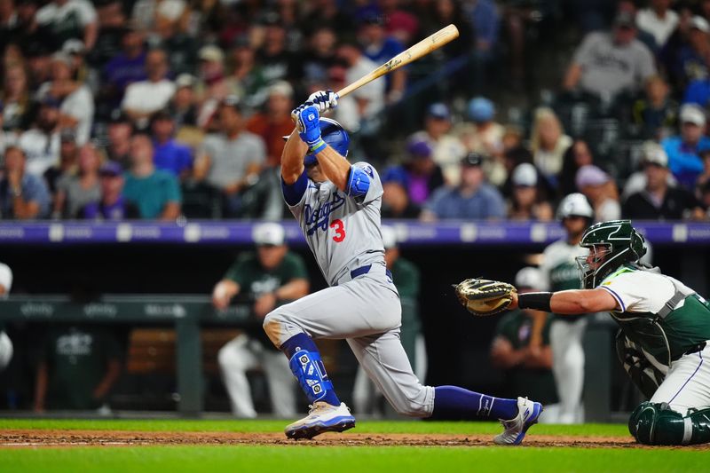 Sep 28, 2024; Denver, Colorado, USA; Los Angeles Dodgers center fielder Chris Taylor (3) RBI singles in the ninth inning against the Colorado Rockies at Coors Field. Mandatory Credit: Ron Chenoy-Imagn Images