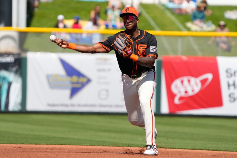 Mar 5, 2024; Scottsdale, Arizona, USA; San Francisco Giants shortstop Marco Luciano (37) makes the play against the Milwaukee Brewers for the out in the first inning at Scottsdale Stadium. Mandatory Credit: Rick Scuteri-USA TODAY Sports