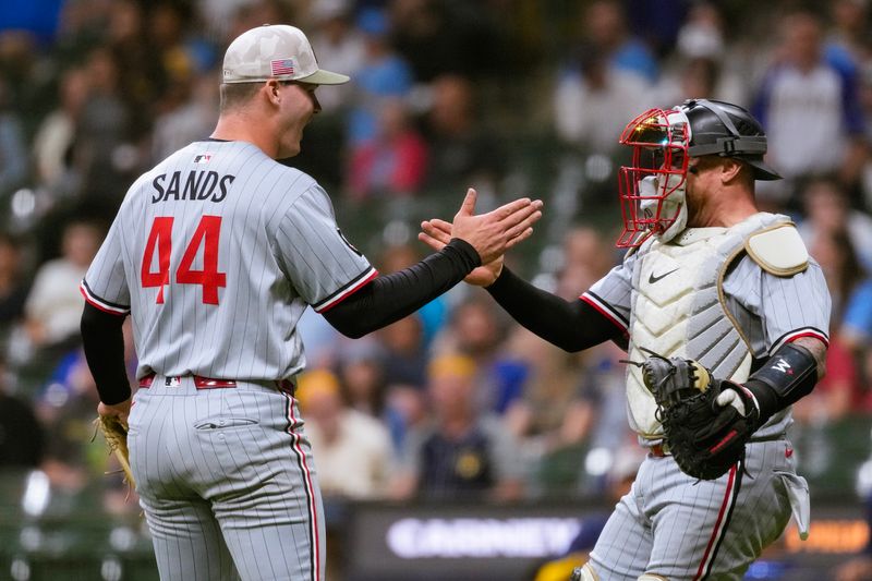 May 16, 2025; Milwaukee, Wisconsin, USA;  Minnesota Twins pitcher Cole Sands (44) greets catcher Christian Vazquez (8) following the game against the Milwaukee Brewers at American Family Field. Mandatory Credit: Jeff Hanisch-Imagn Images