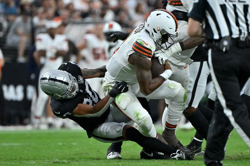 Cleveland Browns quarterback Deshaun Watson is hauled down for a sack by Las Vegas Raiders safety Isaiah Pola-Mao during the second half of an NFL football game Sunday, Sept. 29, 2024, in Las Vegas. (AP Photo/David Becker)