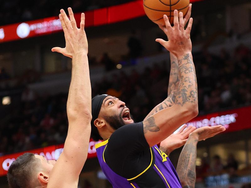 CHICAGO, ILLINOIS - DECEMBER 20: Anthony Davis #3 of the Los Angeles Lakers shoots over Nikola Vucevic #9 of the Chicago Bulls during the first half at the United Center on December 20, 2023 in Chicago, Illinois. NOTE TO USER: User expressly acknowledges and agrees that, by downloading and or using this photograph, User is consenting to the terms and conditions of the Getty Images License Agreement.  (Photo by Michael Reaves/Getty Images)