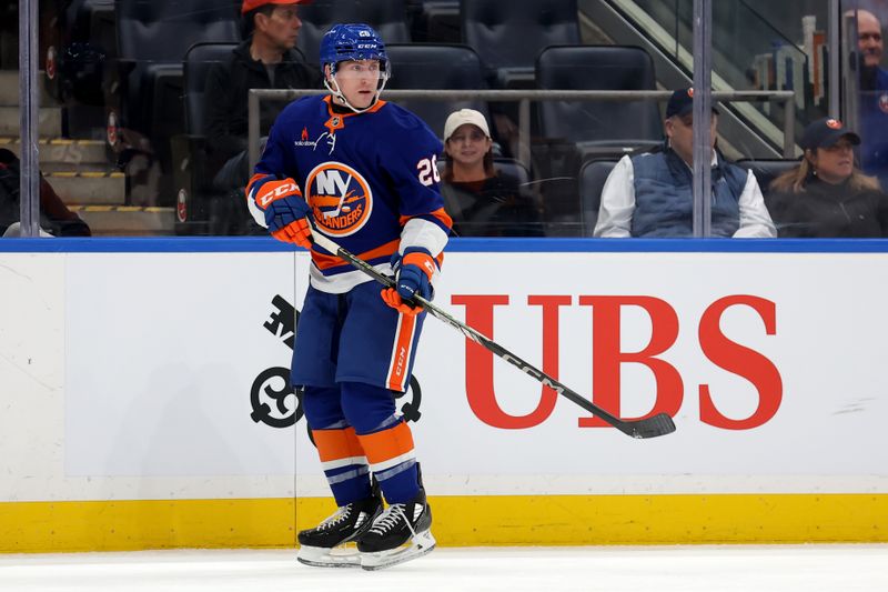 Jan 28, 2025; Elmont, New York, USA; New York Islanders defenseman Scott Perunovich (26) skates against the Colorado Avalanche during the first period at UBS Arena. Mandatory Credit: Brad Penner-Imagn Images