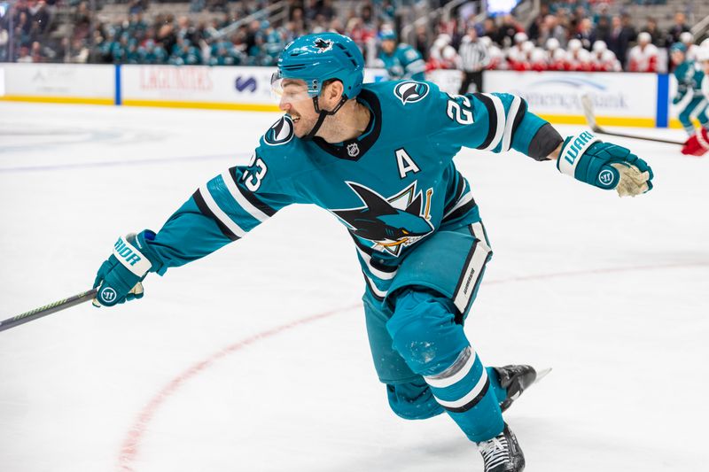 Nov 18, 2024; San Jose, California, USA; San Jose Sharks right wing Barclay Goodrow (23) reaches for the puck during the third period Detroit Red Wings at SAP Center at San Jose. Mandatory Credit: Bob Kupbens-Imagn Images