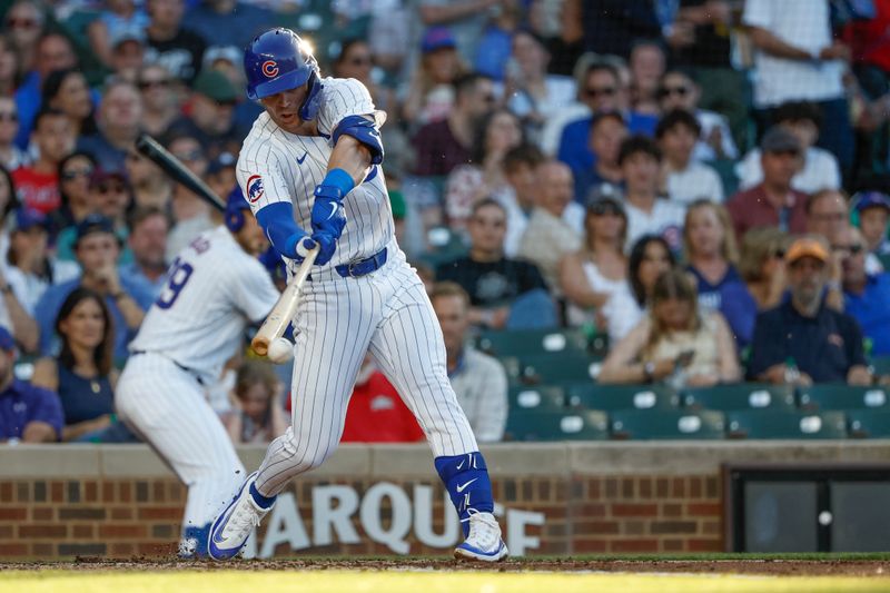 Jun 5, 2024; Chicago, Illinois, USA; Chicago Cubs second baseman Nico Hoerner (2) hits an RBI-single against the Chicago White Sox during the second inning at Wrigley Field. Mandatory Credit: Kamil Krzaczynski-USA TODAY Sports