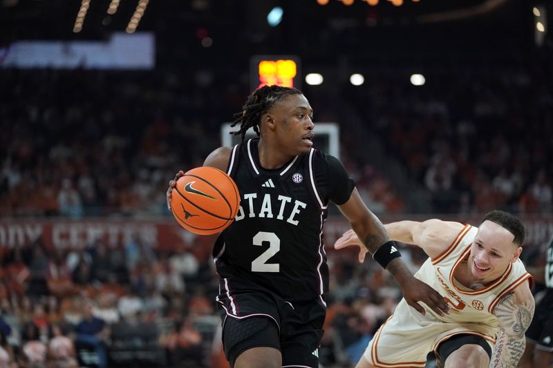 Jan 3, 2026; Austin, Texas, USA; Mississippi State Bulldogs guard Ja’borri Mcghee (2) dribbles against Texas Longhorns guard Chendall Weaver (2) during the second half at Moody Center. Mandatory Credit: Dustin Safranek-Imagn Images