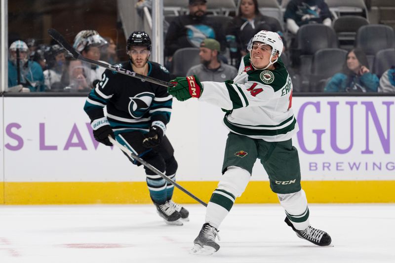 Nov 7, 2024; San Jose, California, USA;  Minnesota Wild center Joel Eriksson Ek (14) shoots the puck during the first period against the San Jose Sharks at SAP Center at San Jose. Mandatory Credit: Stan Szeto-Imagn Images