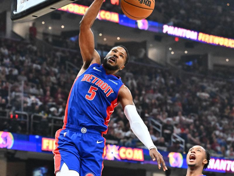 CLEVELAND, OHIO - OCTOBER 25: Malik Beasley #5 dunks as Ronald Holland II #00 of the Detroit Pistons celebrates during the first quarter against the Cleveland Cavaliers at Rocket Mortgage Fieldhouse on October 25, 2024 in Cleveland, Ohio. NOTE TO USER: User expressly acknowledges and agrees that, by downloading and or using this photograph, User is consenting to the terms and conditions of the Getty Images License Agreement. (Photo by Jason Miller/Getty Images)