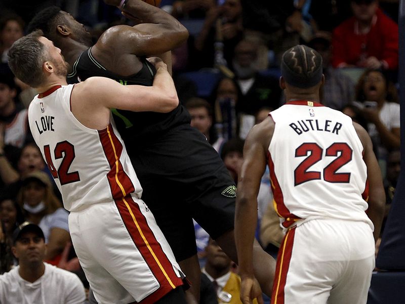 NEW ORLEANS, LOUISIANA - FEBRUARY 23: Zion Williamson #1 of the New Orleans Pelicans is fouled by Kevin Love #42 of the Miami Heat during the fourth quarter of an NBA game at Smoothie King Center on February 23, 2024 in New Orleans, Louisiana. NOTE TO USER: User expressly acknowledges and agrees that, by downloading and or using this photograph, User is consenting to the terms and conditions of the Getty Images License Agreement. (Photo by Sean Gardner/Getty Images)