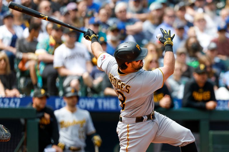 May 28, 2023; Seattle, Washington, USA; Pittsburgh Pirates catcher Austin Hedges (18) hits an RBI-sacrifice fly against the Seattle Mariners during the fifth inning at T-Mobile Park. Mandatory Credit: Joe Nicholson-USA TODAY Sports