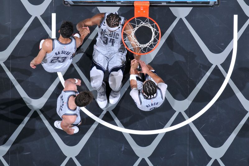 ORLANDO, FL - FEBRUARY 12: Wendell Carter Jr. #34 helped up by Tristan da Silva #23 and Anthony Black #0 of the Orlando Magic during the game against the Charlotte Hornets on February 12, 2025 at Kia Center in Orlando, Florida. NOTE TO USER: User expressly acknowledges and agrees that, by downloading and or using this photograph, User is consenting to the terms and conditions of the Getty Images License Agreement. Mandatory Copyright Notice: Copyright 2025 NBAE (Photo by Fernando Medina/NBAE via Getty Images)