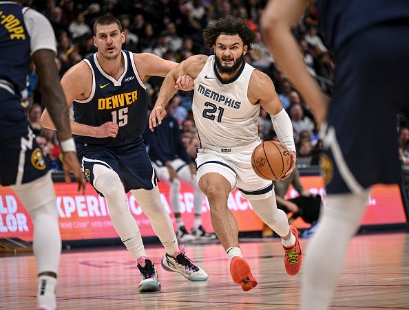 DENVER, CO - DECEMBER 28: David Roddy (21) of the Memphis Grizzlies drives on Nikola Jokic (15) of the Denver Nuggets during the first quarter at Ball Arena in Denver on Thursday, December 28, 2023. (Photo by AAron Ontiveroz/The Denver Post)